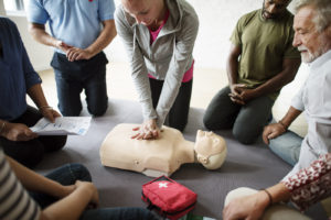 Woman practicing cpr on first aid training