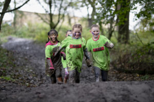 Children running a race through mud