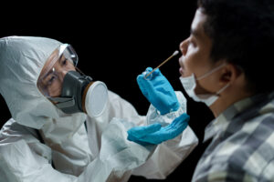 doctor wearing PPE conducting coronavirus test